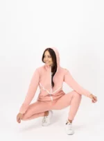 Mujer usando conjunto de pants color rosa palo.