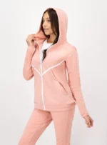 Mujer usando conjunto de pants color rosa palo.